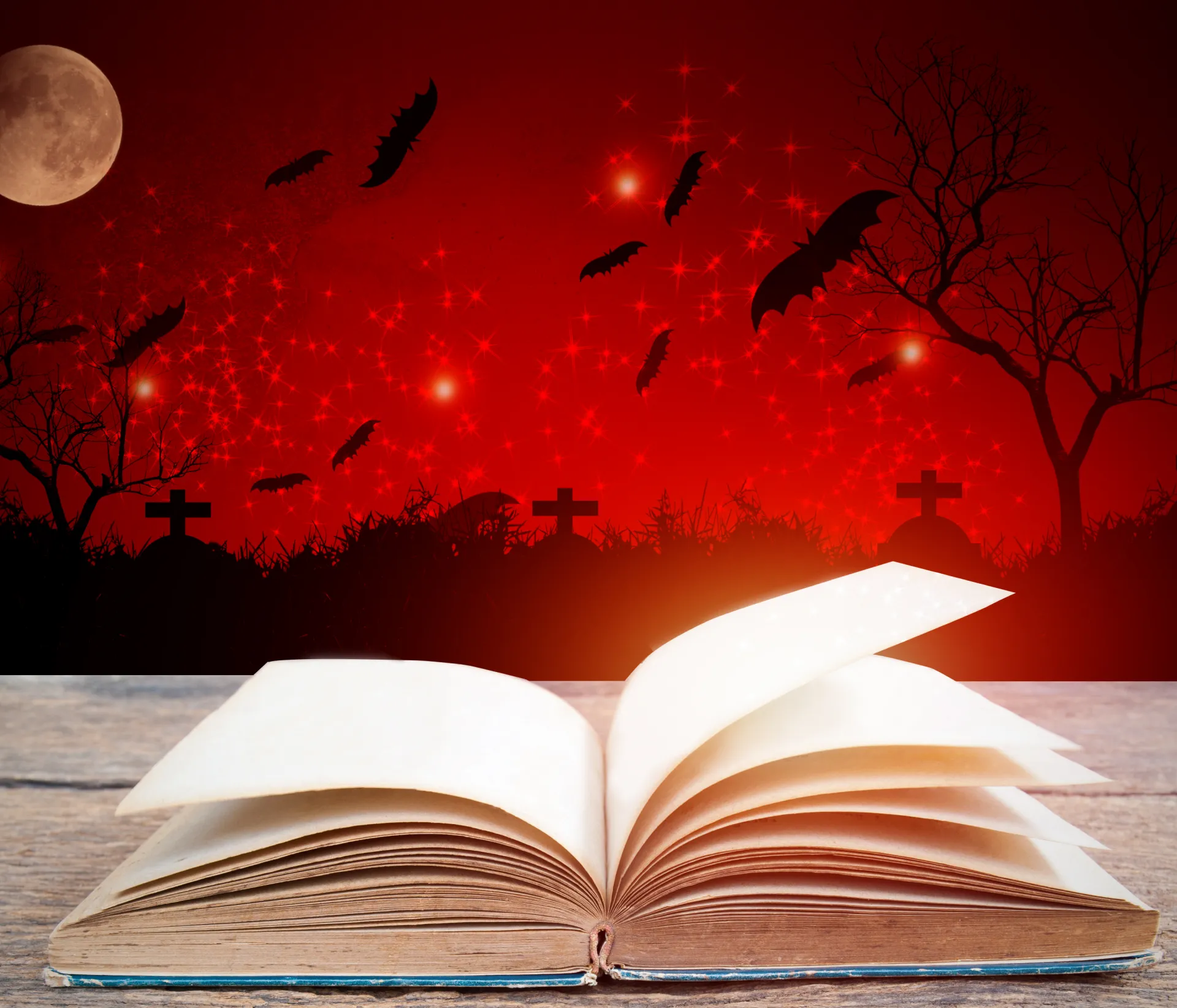 GettyImages-1051571660 A book open to an image of bats flying in the sky.