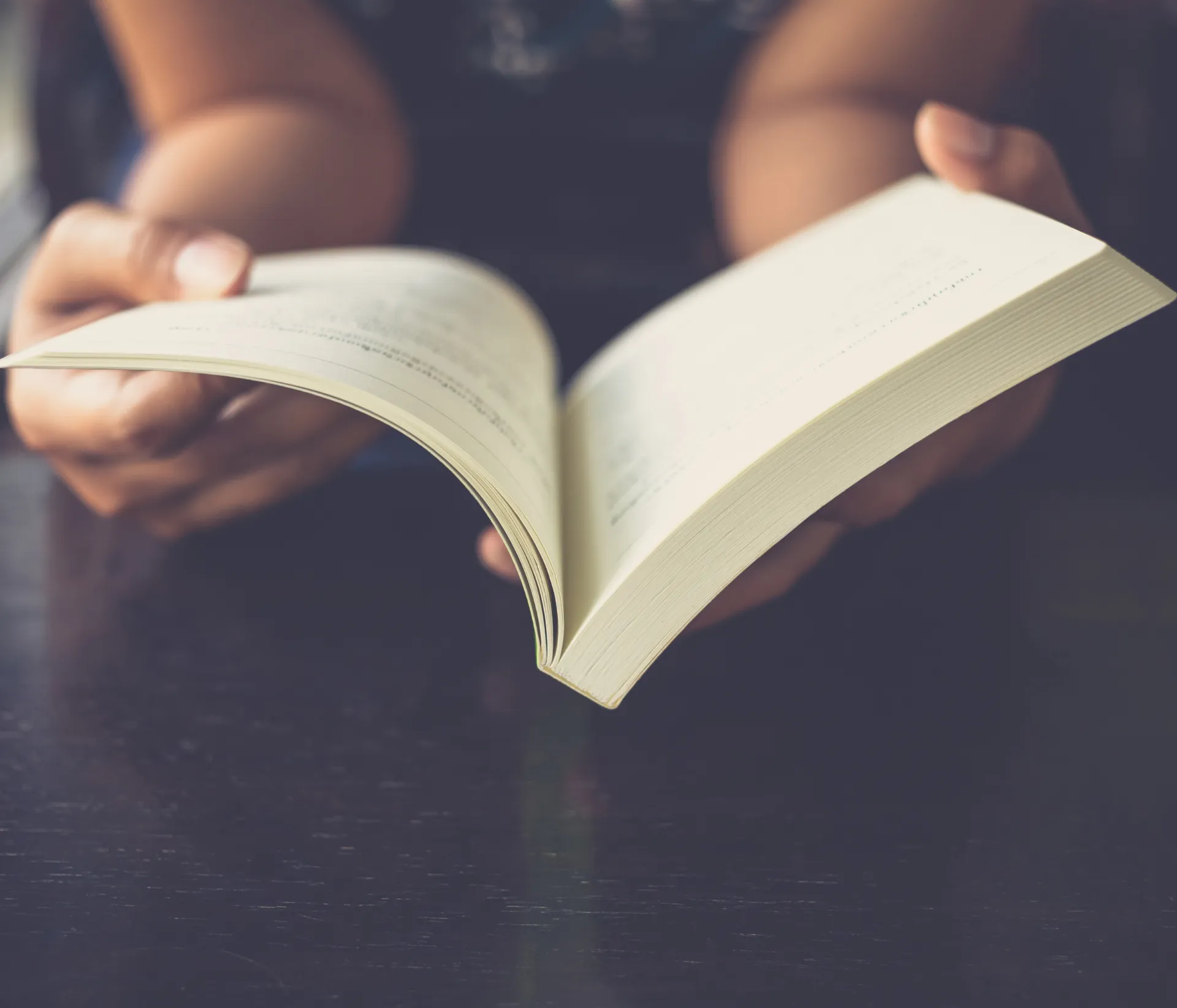 GettyImages-508586144 A person sitting down reading a book
